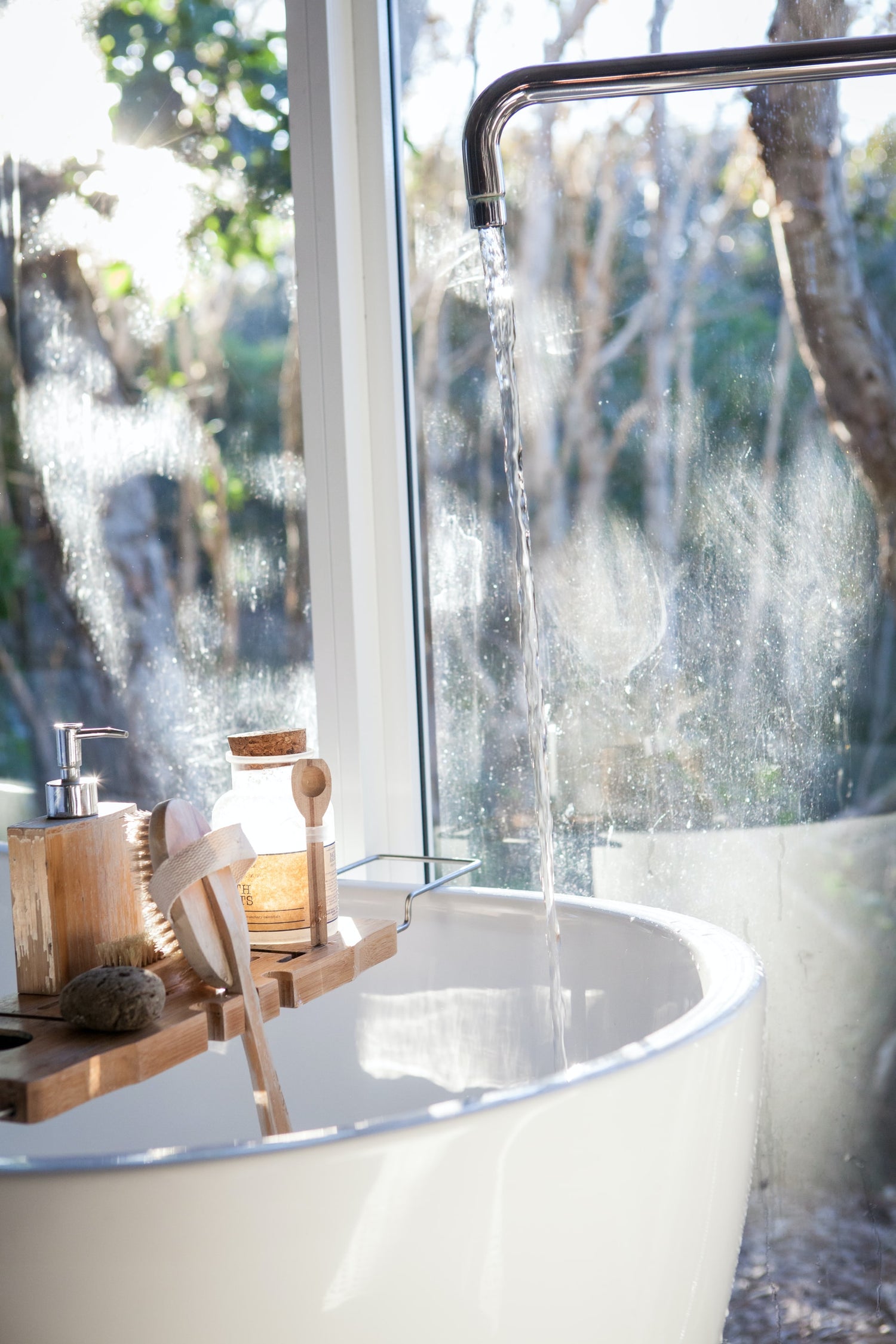 a bath with body care products and running water